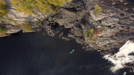Kayaker-On-Muskoka-River-During-Autumn-In-Ontario-With-High-Falls-Revealed