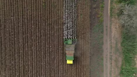 Cotton-picker-harvesting-a-field,-Top-down-aerial-view