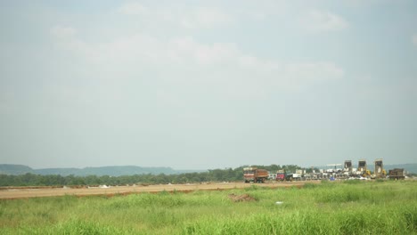 Static-shot-of-construction-site-of-Samruddhi-Mahamarg-or-Nagpur-to-Mumbai-Super-Communication-Expressway-under-construction,-the-six-lane-highway-passes-through-many-mountains-and-agricultural-lands