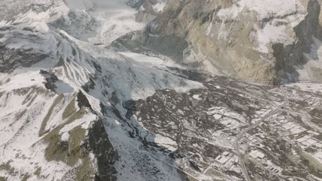 Aerial-Flying-Over-Pasu-Glacier-And-Valley-Floor-To-Reveal-Epic-Passu-Cones-In-the-Karakoram-Range-In-The-Distance