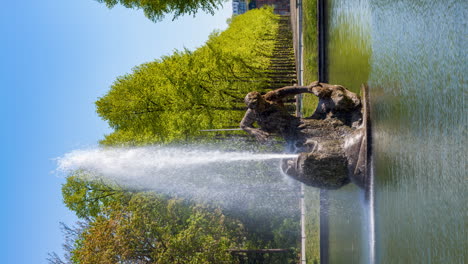 Fountain-in-"Hofgarten"-Duesseldorf-on-a-sunny-day,-Vertical-video-Time-lapse