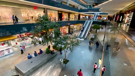 people-in-a-shopping-mall-during-the-"new-normal"-post-coronavirus-some-wearing-face-masks