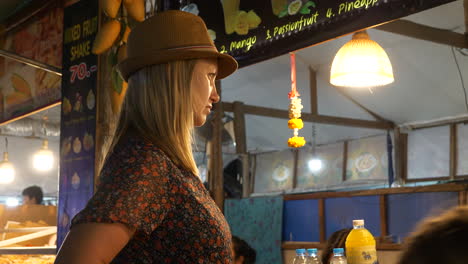 Woman-waiting-for-her-order-at-an-Asian-food-market