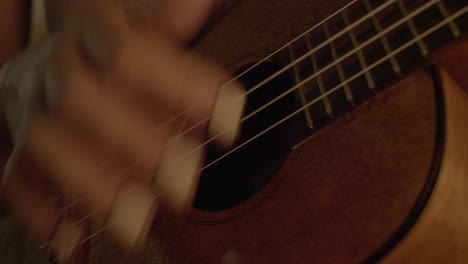 Girls-hand-strumming-guitar-night-CLOSE-UP