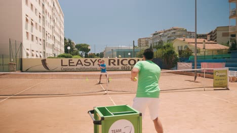 Young-girl-and-personal-trainer-at-private-tennis-class,-slow-motion