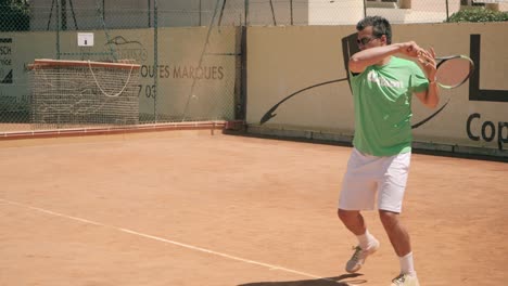 Tennis-player-strike-dusty-ball-with-racket-in-slow-motion