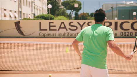 Friendly-tennis-lesson-between-coach-and-student,-slow-motion-from-behind