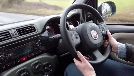 car-being-driven-along-country-road,-from-inside-car-in-the-UK