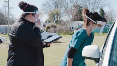 Medical-workers-with-face-masks-helping-in-outdoor-covid19-test-facility