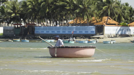 Local-fisherman-returning-from-fishing-trip-in-Vietnam,-follow-up-view