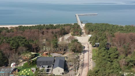 AERIAL:-Basanaviciaus-Central-Pedestrian-Street-of-Palanga-with-Palanga-Pier-in-Background