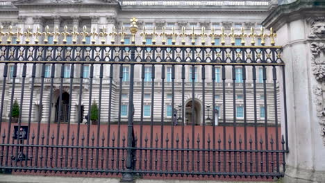 Slow-motion-shot-of-a-Queen's-guard-and-a-armed-police-office-walking-right-next-to-each-other