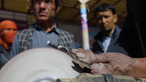 Rustic-Hacksaw-Being-Sharpened-By-A-Pedal-Grinder-In-Bamyan,-Afghanistan