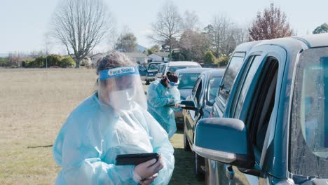 Long-Covid19-vaccine-facility-with-workers-in-PPE-gathering-peoples-information