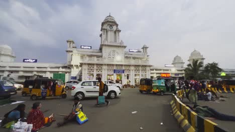 A-side-angel-shot-of-crowd-and-vehicles-at-an-Indian-railway-station-at-sunset-time