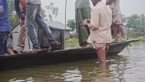 People-disembarking-from-a-boat-with-a-television