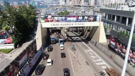 Traffic-heading-in-and-out-of-Hong-Kong-cross-harbor-tunnel,-Aerial-view