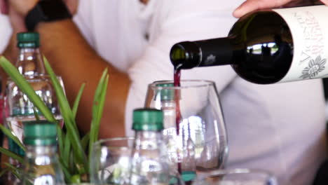 Red-wine-being-poured-onto-a-wine-glass,-close-up-in-slow-motion