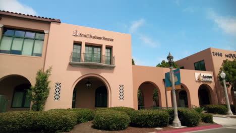 Road-Trip-Passing-By-The-Historic-Liberty-Station-Barracks-Buildings-At-Daytime-In-San-Diego,-California