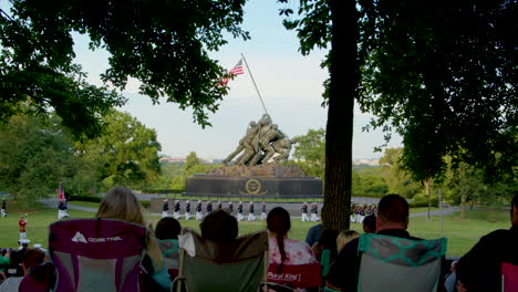 A-large-formation-of-United-States-Marines-parade-on-a-field-in-front-of-the-USMC-War-Memorial-in-Arlington,-Virginia-on-a-summer-evening