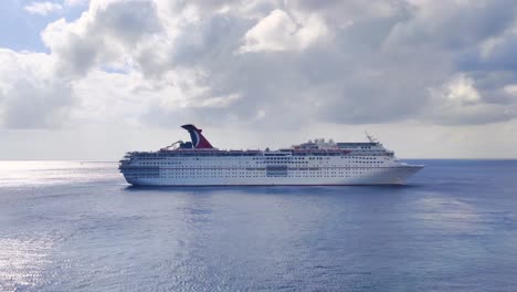 Carnival-Cruise-liner-sailing-from-port-of-Mexico-in-middle-of-the-Caribbean-sea-with-cloudy-weather-video-background-in-4K-|-Carnival-cruise-ship-sailing-in-middle-of-the-Caribbeans-sea-video-in-4K