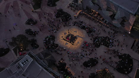 High-angle-aerial-perspective-looking-down-from-above-onto-Federation-Square-precinct-with-many-on-lookers-waiting-for-concert-to-begin