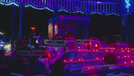 Lights-flash-as-people-enjoy-the-excitement-of-a-carnival-ride-on-a-summer-evening-at-the-fair