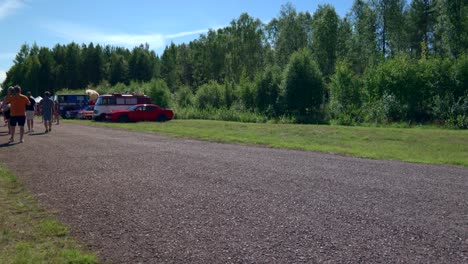 Vintage-Convertible-Car-Passing-at-a-Classic-Car-Meet,-Meetup-for-Old-American-Car-Enthusiasts-in-Sweden