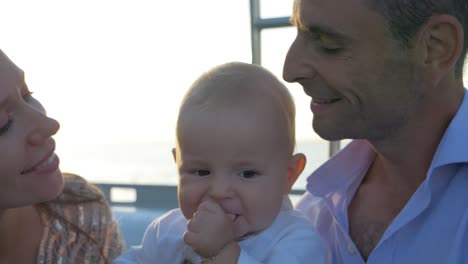 Happy-family-kiss-on-a-catamaran-sailboat-in-the-Mediterranean-ocean-near-France