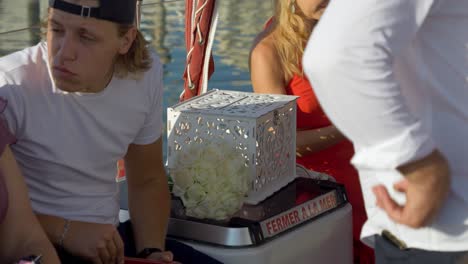 Teenager-talking-to-someone-while-sitting-on-the-side-of-a-sailing-boat