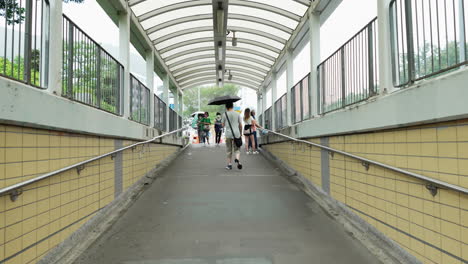 China,-Hong-Kong--August-11,-2022:-people-walking-towards-the-main-road-from-the-aisle-of-the-subway-line