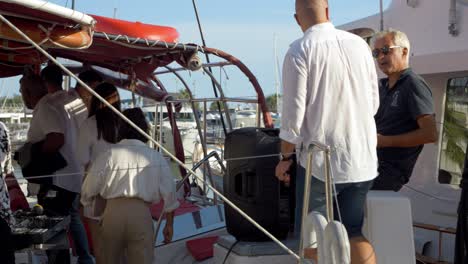 People-entering-the-catamaran-sail-boat-in-the-marina-of-Grande-Motte,-France