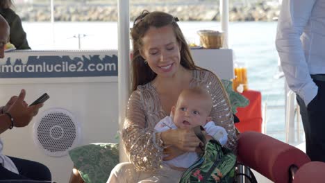 Happy-mom-smiling-at-her-baby-on-a-Catamaran-sail-boat