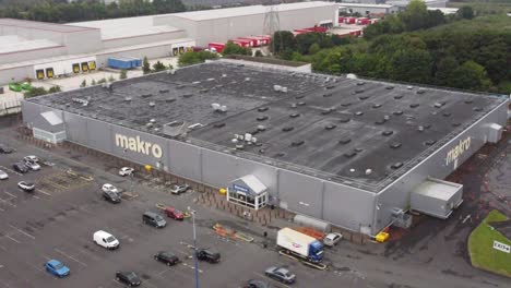 Aerial-view-makro-cash-and-carry-wholesale-supermarket-store-exterior-slow-descend