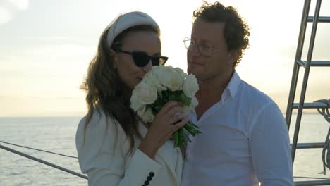 Cute-couple-smelling-flowers-on-a-sailing-boat