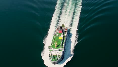 Aerial-shot-of-a-Caledonian-Macbrayne-ferry-sailing-over-dark-blue-water