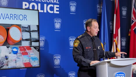 Police-officer-speaks-at-a-press-conference,-announcing-the-capture-of-illegal-drugs