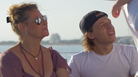 Mother-and-son-enjoying-a-sunny-day-on-a-sailing-boat