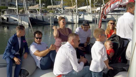 People-relax-in-the-back-of-a-Catamaran-sail-boat-in-the-Marina-of-Montpellier,-France