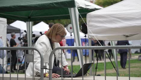 Woman-Reporter-Researching-On-Laptop-Inside-Media-Village-Covering-UK's-Next-Prime-Minister-On-5-Sept-2022