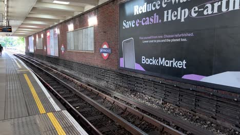 London-Underground-Train-Leaving-Station-at-High-Speed-Moving-Past-Camera-from-Platform-View