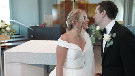 Bride-kissing-groom-in-modern-church.-Tilt-shot