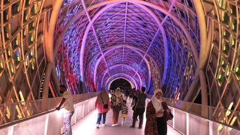 Static-Shot-From-Inside-The-Incredible-Saloma-Bridge-With-Tourists-Walking-By-In-Kuala-Lumpur,-Malaysia