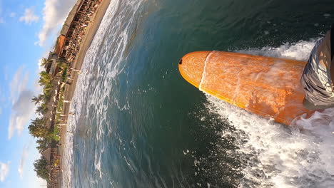 Vertical-shot-of-surfer-on-yellow-surfboard,-surfing-towards-beach