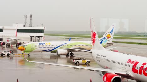 Nok-Air's-Boeing-737-is-being-pushed-back-and-started-up-at-Donmuang-Airport,-Bangkok,-Thailand