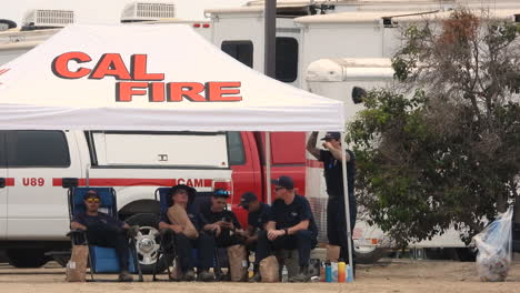 California-Department-Of-Forestry-And-Fire-Protection-Firefighters-Sitting-Under-A-Tent-Near-Hemet-In-California,-USA