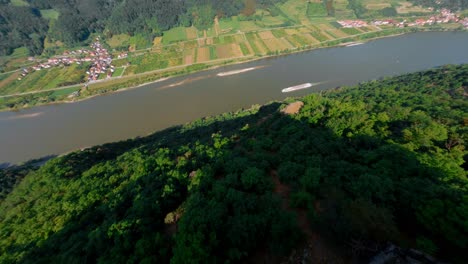 FPV-Diving-Fast-Down-Towards-Ferry-Boat-Sailing-In-Danube-River,-Tischwand,-Austria