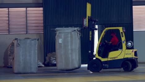 Using-a-forklift-to-move-a-huge-bag-of-freshly-harvested-coffee-beans-at-the-factory