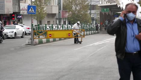 Motorbikes-and-cars-driving-through-traffic-in-Tehran,-Iran