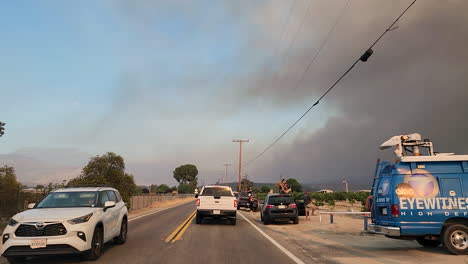 Espectadores-En-La-Carretera-Viendo-El-Incendio-Forestal-De-Fairview-Con-Camiones-De-Bomberos-Pasando